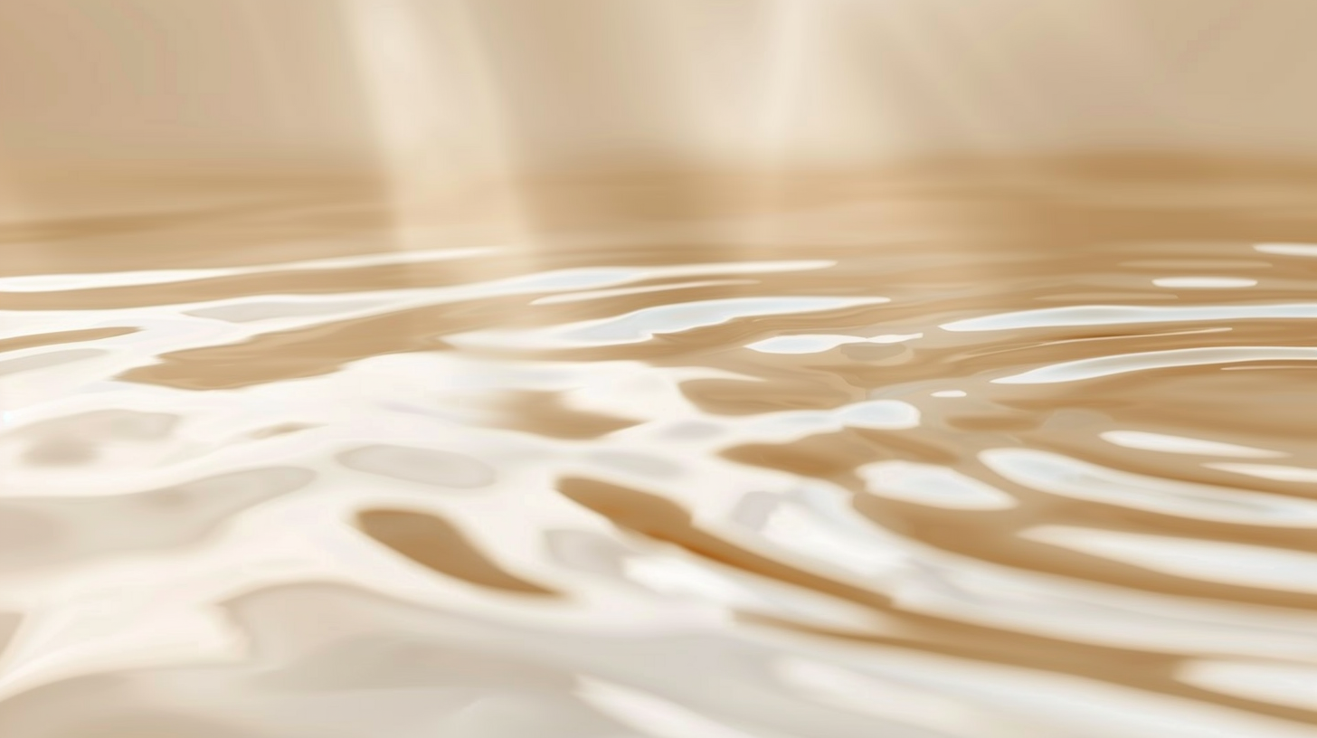 Abstract Close-up of a smooth, beige  water surface with soft lighting